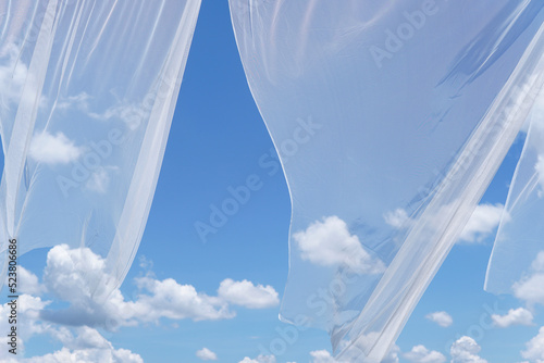 White transparent curtain blown in the blue sky and white clouds, beautiful sky backdrop.