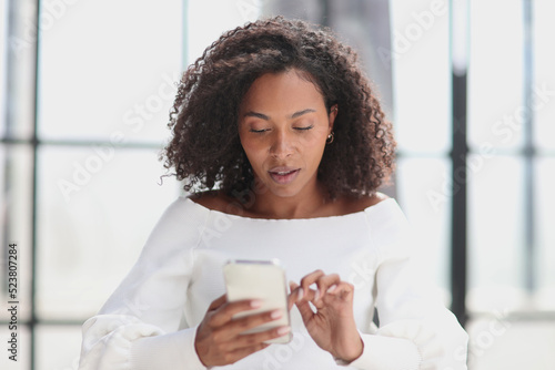 Portrait of a young attractive African American woman using a smartphone
