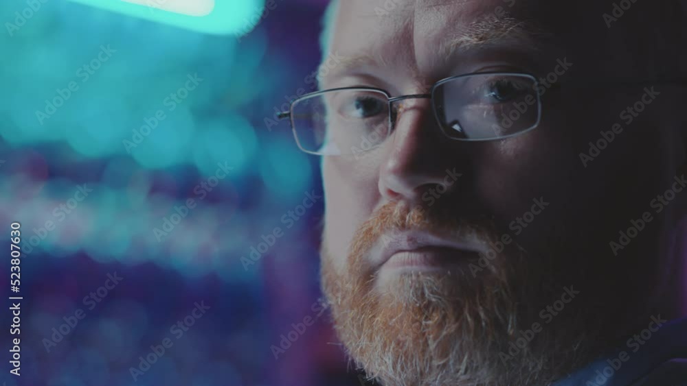 Portrait of Caucasian bearded man posing for camera in dark server room while working as system administrator in data center Portrait of Caucasian bearded man posing for camera in dark server room while working as system administrator in data center