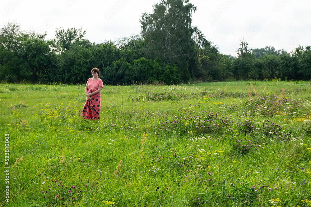 Beautiful woman walking in the field.
Woman on active vacation in the field. She is resting after work.
