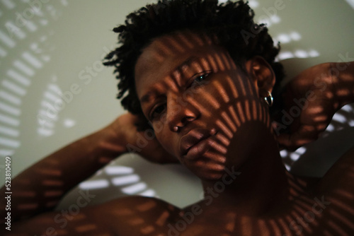 portrait of a young african american man with shadows on his face