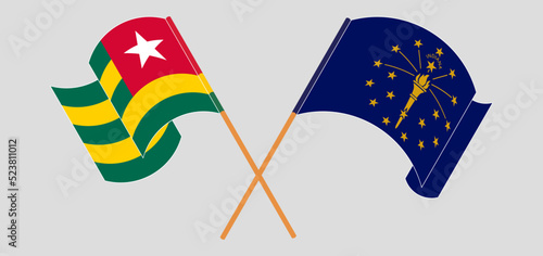 Crossed and waving flags of Togo and the State of Indiana