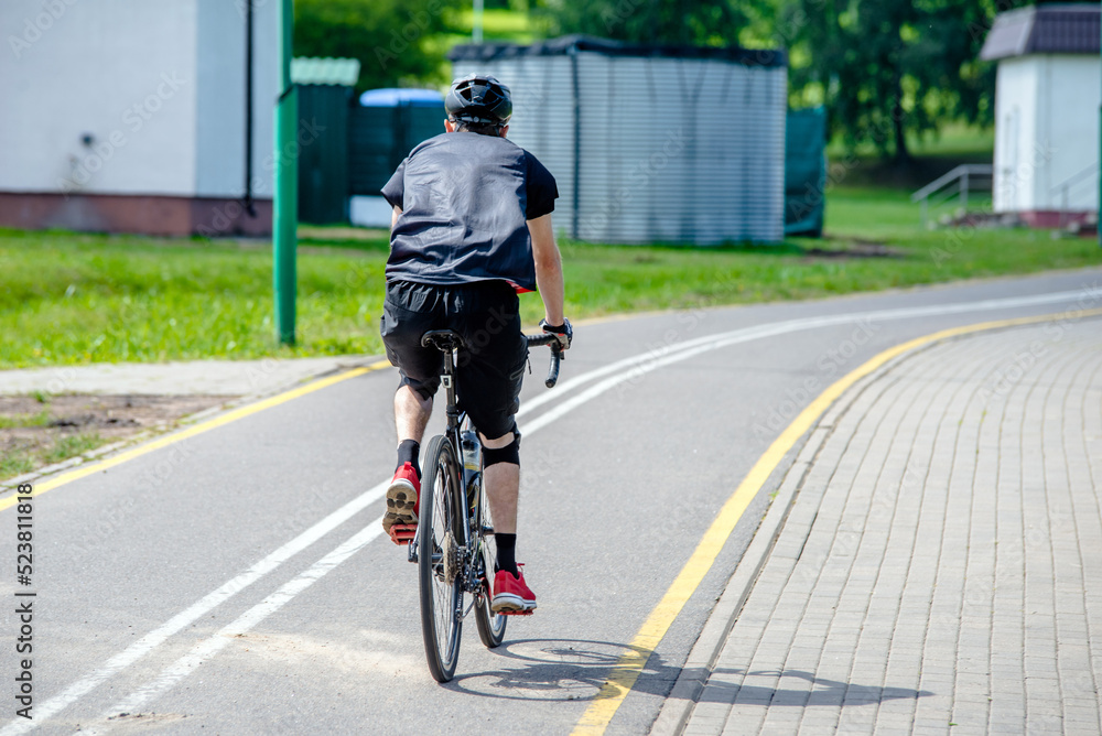 Fototapeta premium Cyclist ride on the bike path in the city Park 