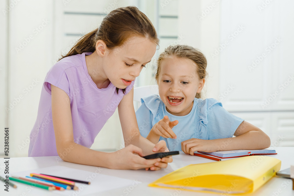 Child and electronic devices concept. Portrait of toddler with smartphone.little child girl using digital tablet at home. kid using gadgets for learning. Child and electronic devices concept. Portrait of toddler with smartphone.little child girl using digital tablet at home. kid using gadgets for learning.