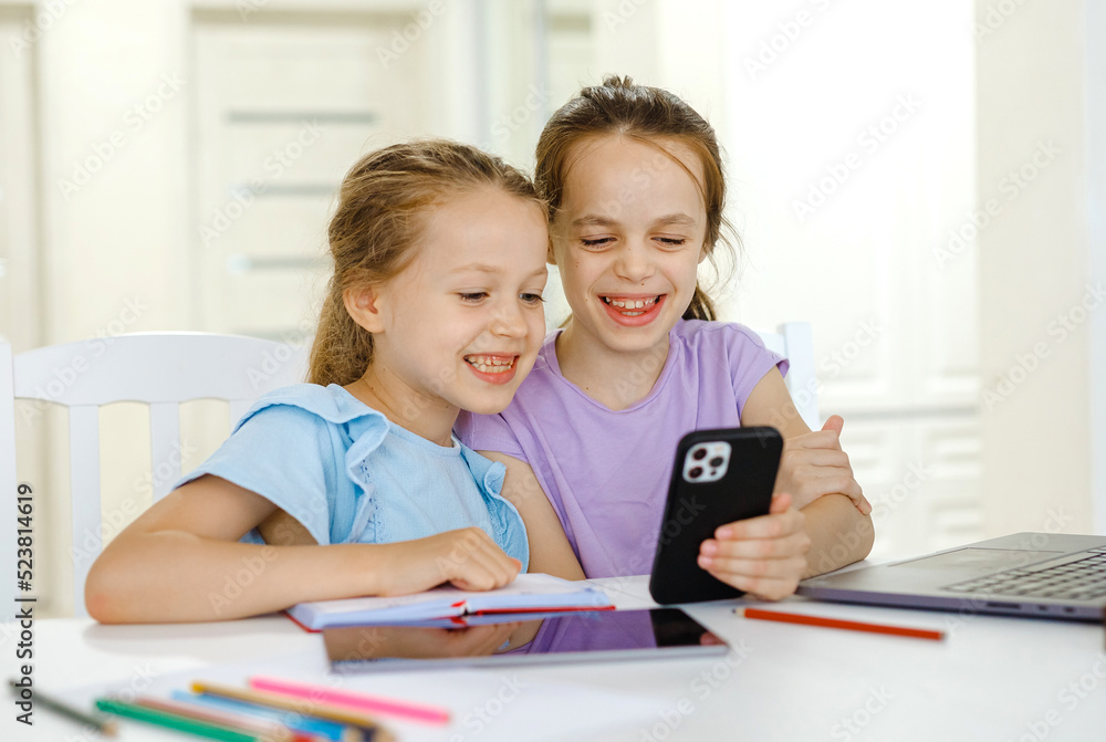 Cheerful girls having online lesson Cheerful girls having online lesson