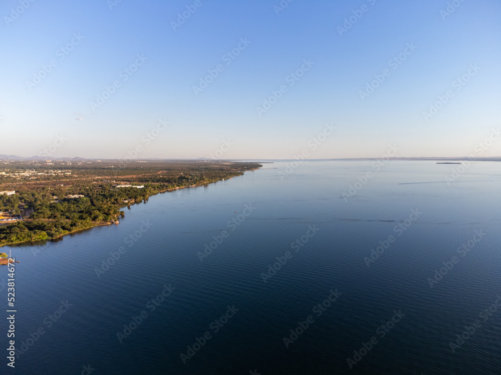 Green piece of land with trees on the banks of the great lake of the Tocantins River in Palmas