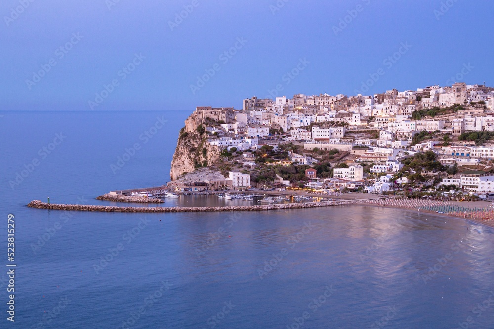 Scenic sunset view over historic old town of Peschici, Gargano, Apulia, Italy
