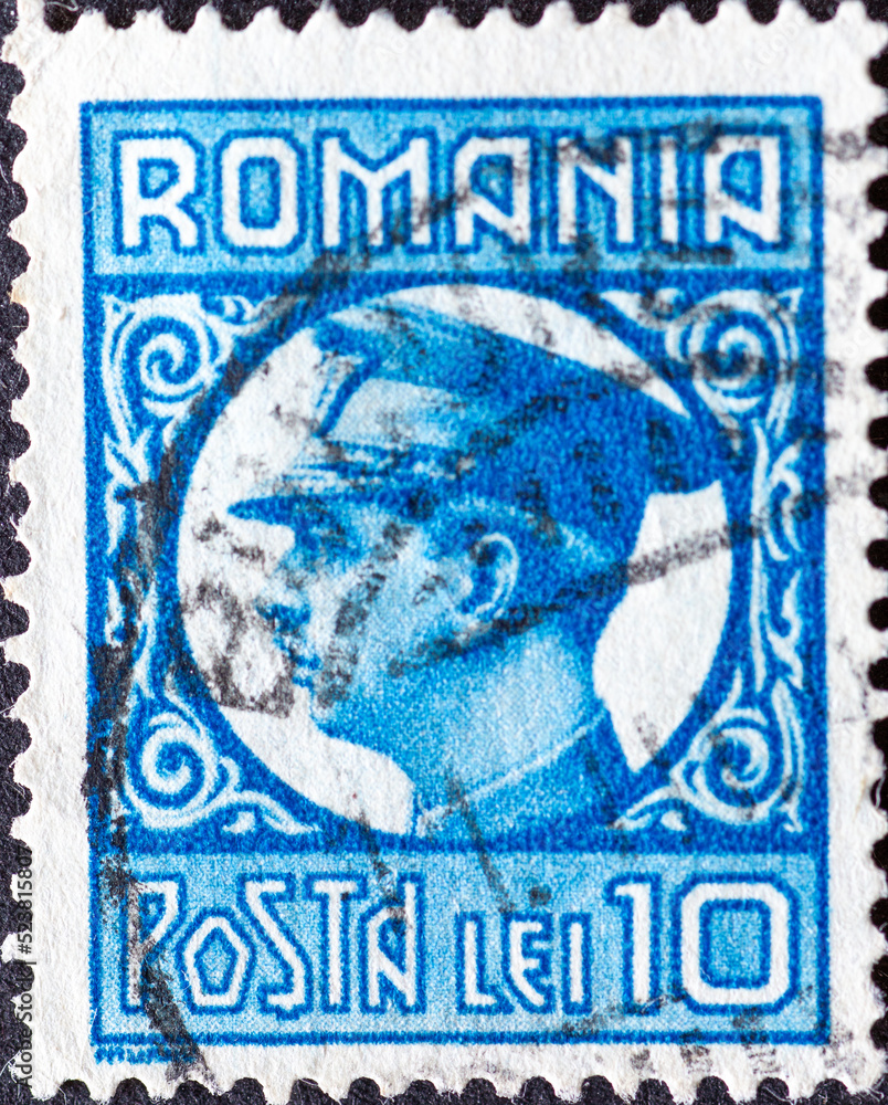 Naklejka premium ROMANIA - CIRCA 1932: a postage stamp from Romania , showing a portrait of Carol II of Romania (1893-1953). In military uniform . Circa 1932