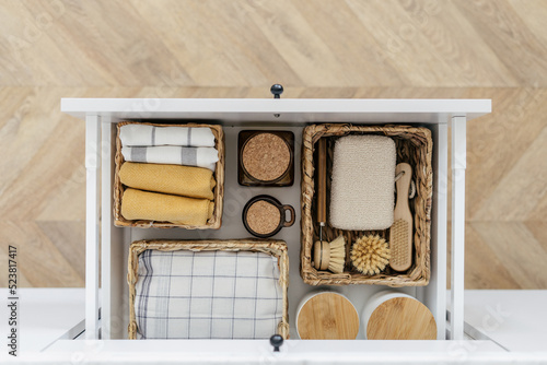 Eco-friendly products and towels in drawer organizer photo