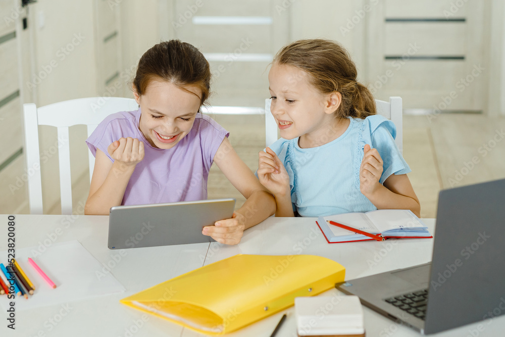 Child and electronic devices concept. Portrait of toddler with smartphone.little child girl using digital tablet at home. kid using gadgets for learning. Child and electronic devices concept. Portrait of toddler with smartphone.little child girl using digital tablet at home. kid using gadgets for learning.