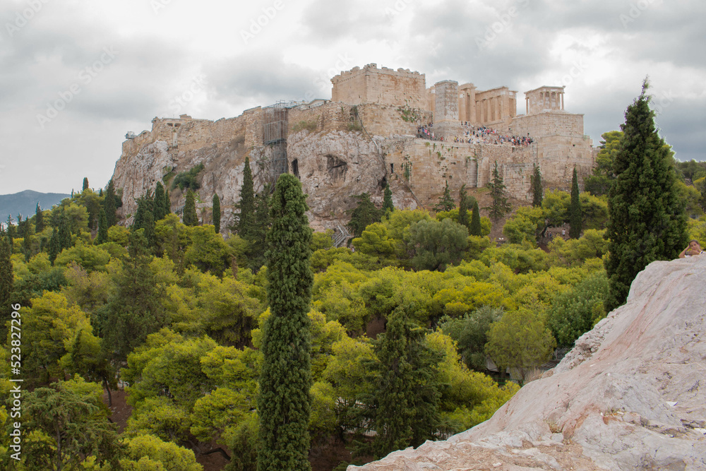Panoramic view of the Acropolis with the green forest around it, in the city of Athens, Greece. 