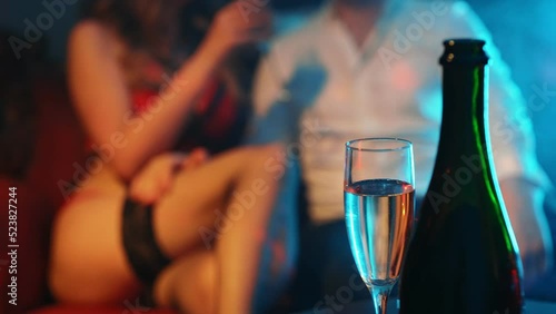 Woman flirting with man in strip club.