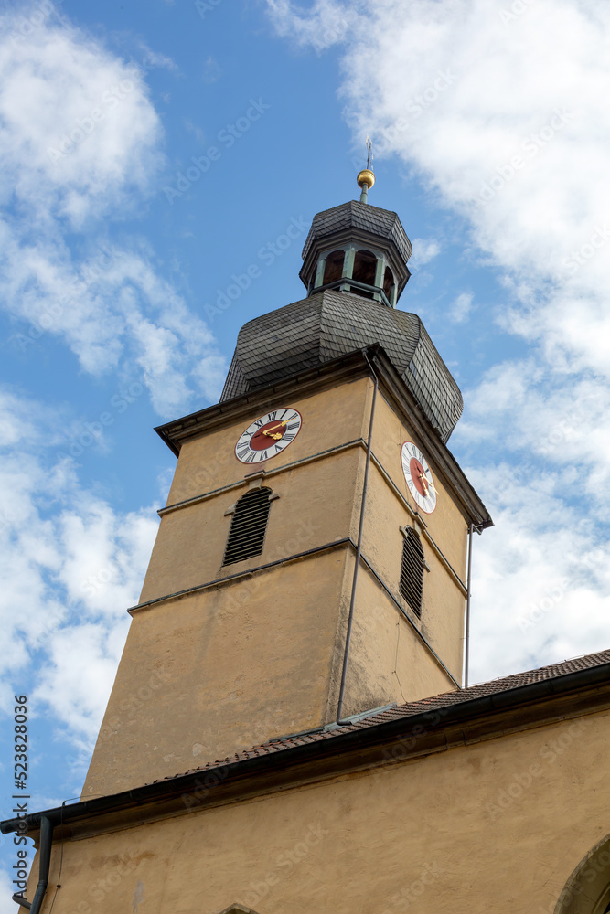 view of an old church tower and cloudy blue sky view of an old church tower and cloudy blue sky