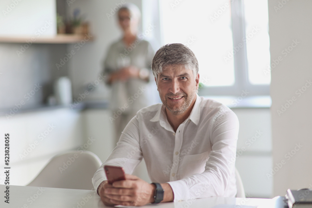 successful businessman holding a phone in his hand