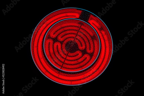 close-up of a round red glowing induction stove
