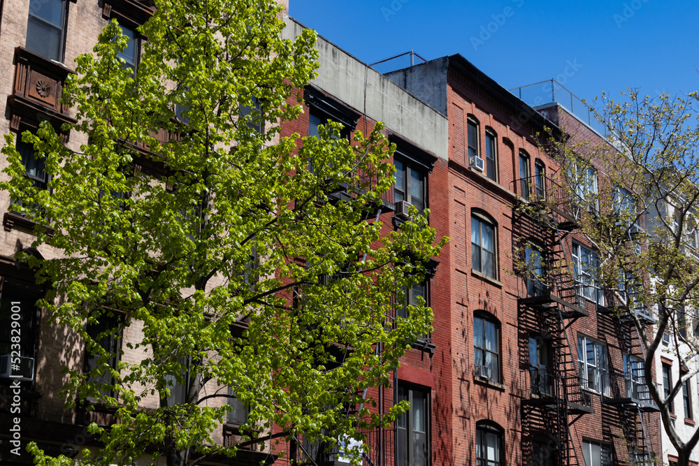 Naklejka premium Row of Colorful Old Brick Apartment Buildings in the East Village of New York City during Spring