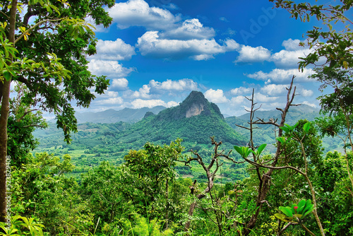 View from the temple Wat Pra Putthabat Phu Kwai Ngoen (the Rabbit Temple) in Chiang Khan over the forested mountains and valleys of the province of Loei, Thailand 