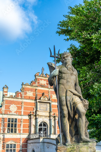 Neptune statue at the entrance of Borsen, building of the Chamber of Commerce, in Copenhagen, Denmark photo