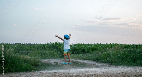 Child running in a corn field