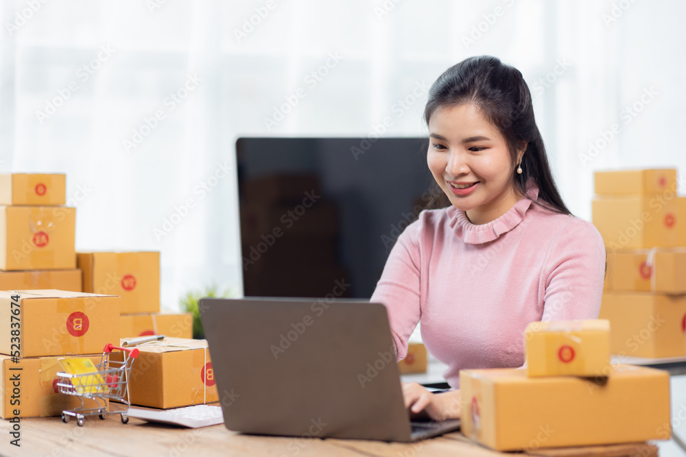 Portrait of young Asian woman working SME with a box at home the workplace.start-up small business owner, small business entrepreneur SME or freelance business online and delivery concept. Portrait of young Asian woman working SME with a box at home the workplace.start-up small business owner, small business entrepreneur SME or freelance business online and delivery concept.