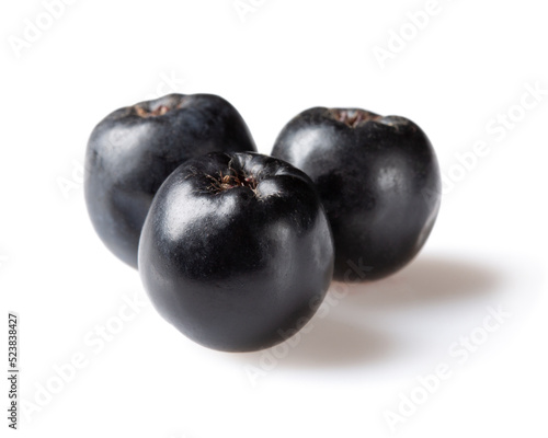 Chokeberry, aronia melanocarpa. Three black chokeberry berries isolated on white background.