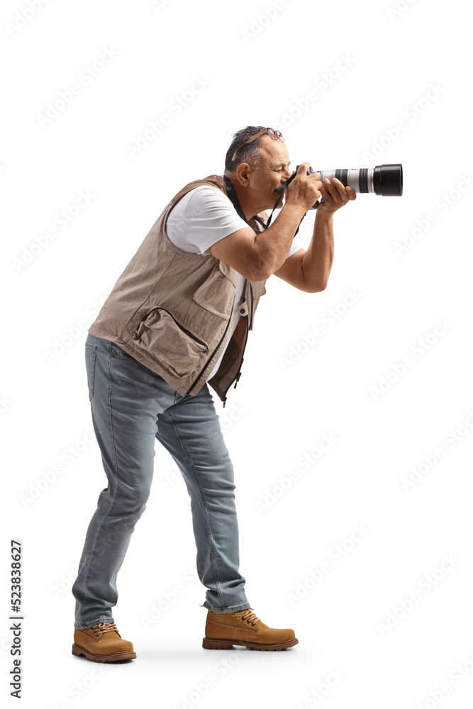 Full length profile shot of a man taking a photo with a professional camera