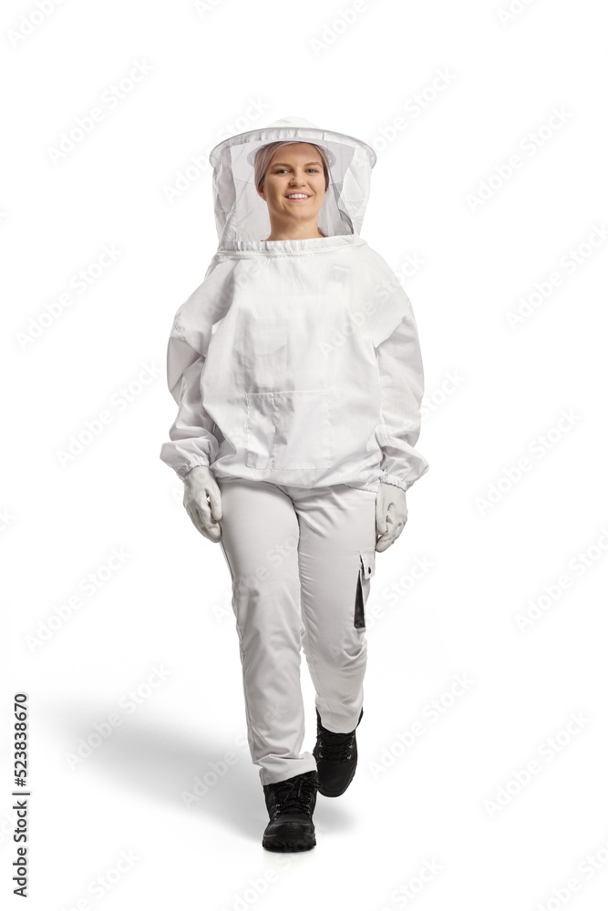 Full length portrait of a female bee keeper in a uniform walking Full length portrait of a female bee keeper in a uniform walking