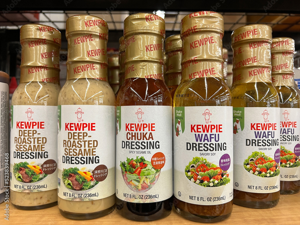 Oakland, CA July 1, 2022 Grocery store shelf with bottles of Kewpie