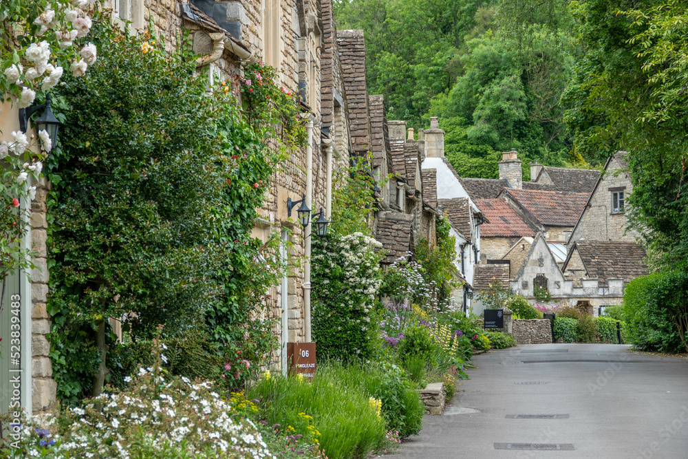 honey coloured Cotswold stone houses in Castle
Combe Wiltshire England often named as the 
prettiest village in England