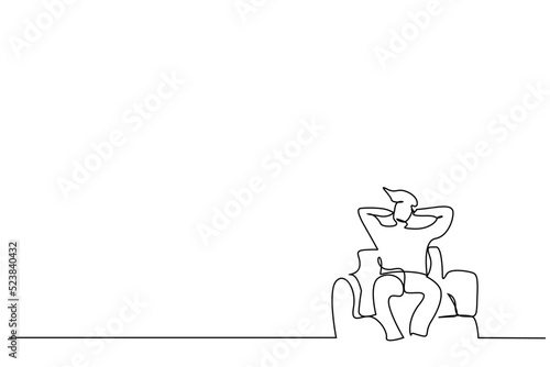 man sitting on sofa calm relax way with hands behind head