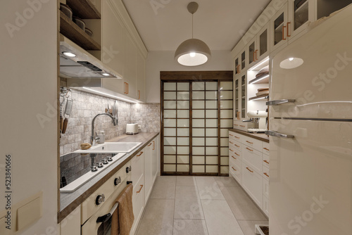 Modern Japandi kitchen interior design in earth tones  natural textures with wooden solid oak furniture and sliding Japanese wood doors. Japandi concept