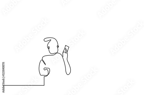 old man holding phone and coffee mug standing looking at messages