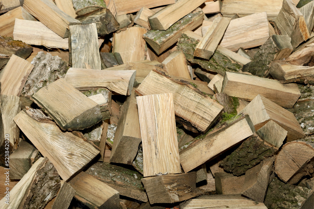 A stack of firewood harvested for the winter. Pile of firewood dries before winter A stack of firewood harvested for the winter. Pile of firewood dries before winter