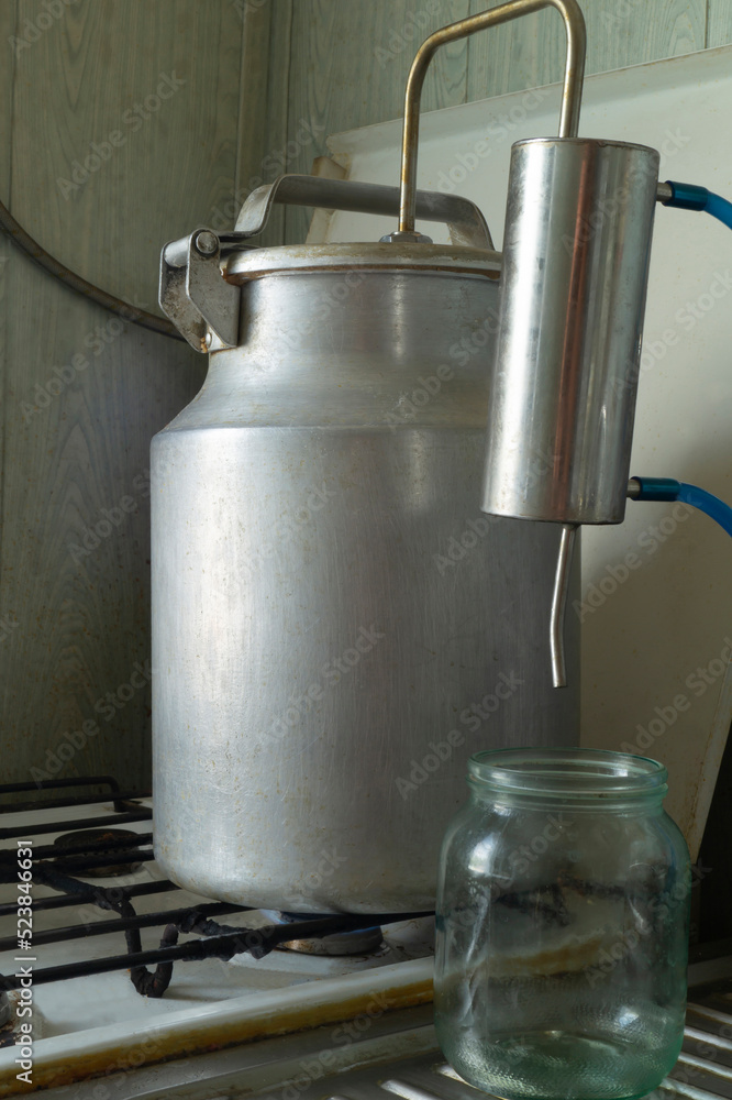 The moonshine still stands on a gas stove The moonshine still stands on a gas stove