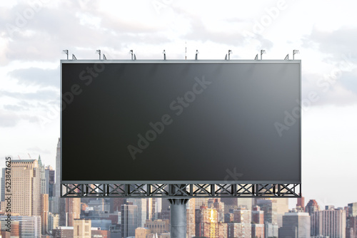 Blank black horizontal billboard on cityscape background, front view. Mockup, advertising concept
