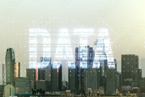 Data word hologram on Los Angeles office buildings background, big data and blockchain concept. Multiexposure