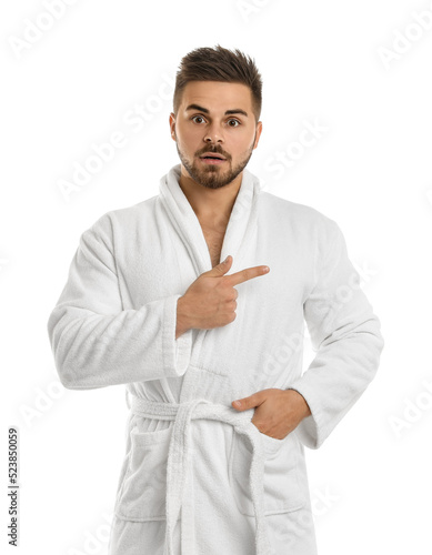 Handsome man wearing bathrobe on white background