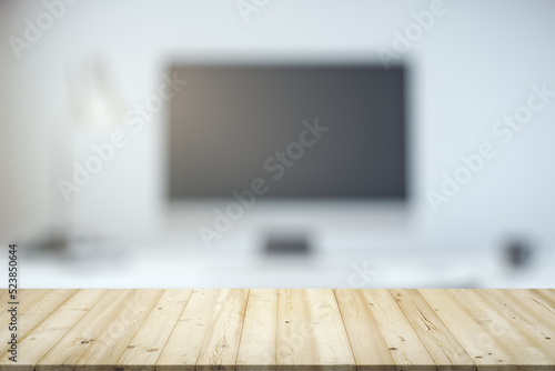 Empty office wooden table with empty space on modern workplace with computer background, closeup, mock up © Pixels Hunter