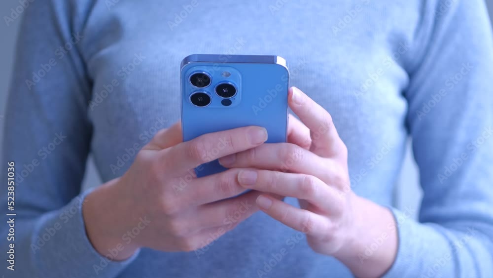 Woman using mobile phone. Girl typing sms message on new smartphone in closeup 4K video clip Woman using mobile phone. Girl typing sms message on new smartphone in closeup 4K video clip