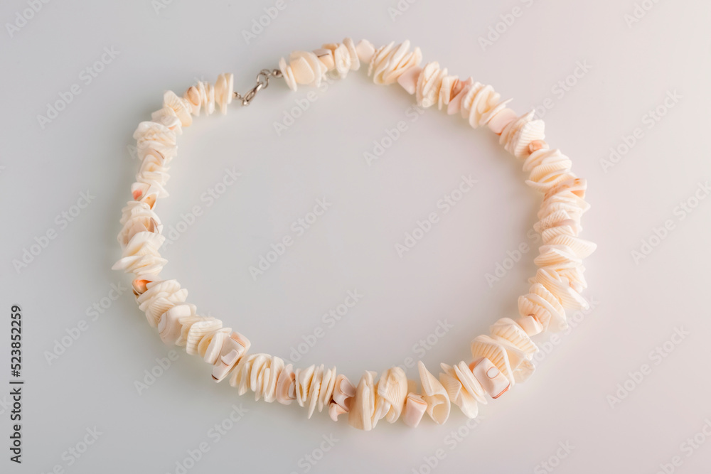 Obraz premium Close-up of a shell necklace with a defocused background. Handmade jewelry