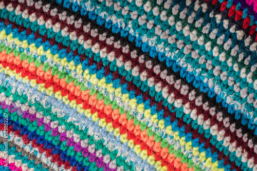 Knitted background from colored threads. The concept of knitting warm clothes, rugs