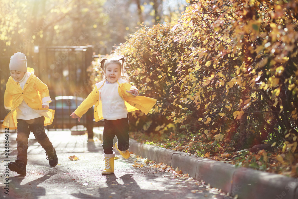 Children walk in the autumn park Children walk in the autumn park
