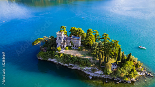 Amazing lake Iseo scenery with picturesque small island Loreto with castle, aerial drone view. Italy, Brescia province