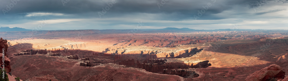 Scenic Panoramic View of American Landscape and Red Rock Mountains in Desert Canyon. Cloudy Sunset Sky. Canyonlands National Park. Utah, United States. Nature Background Panorama Scenic Panoramic View of American Landscape and Red Rock Mountains in Desert Canyon. Cloudy Sunset Sky. Canyonlands National Park. Utah, United States. Nature Background Panorama