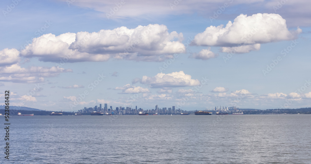 Downtown City Skyline with Industrial Cargo Ships. Sunny Cloudy Day. Vancouver, British Columbia, Canada. Downtown City Skyline with Industrial Cargo Ships. Sunny Cloudy Day. Vancouver, British Columbia, Canada.