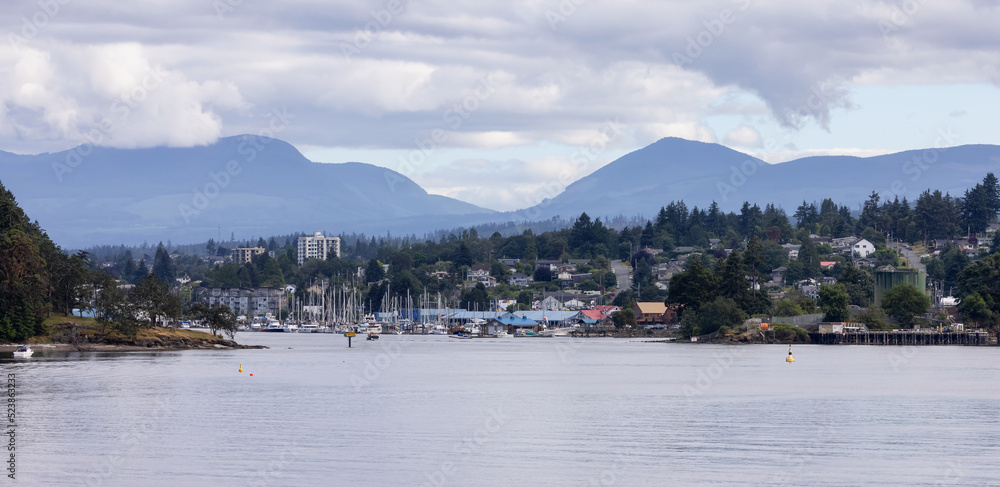 City by the water, Marina with Boats, surrounded by Homes, mountains and trees. Summer Season. Nanaimo, Vancouver Island, British Columbia, Canada. City Background.