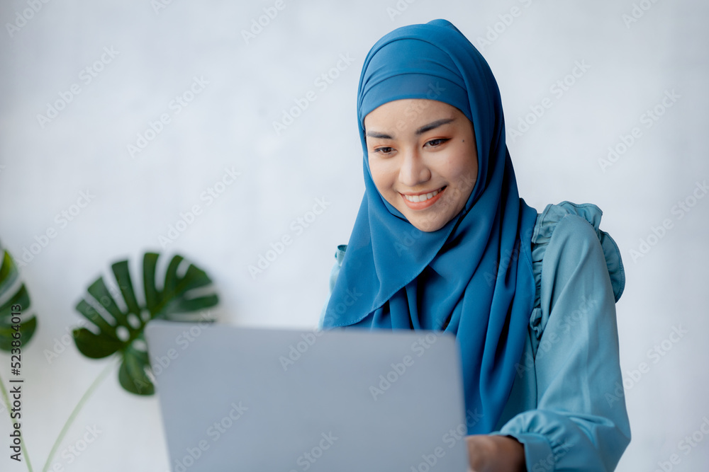 Asian women wearing hijab sitting in the office of a startup company, managed and operated by a young, talented working woman. The management concept drives the company of women leaders to grow. Asian women wearing hijab sitting in the office of a startup company, managed and operated by a young, talented working woman. The management concept drives the company of women leaders to grow.
