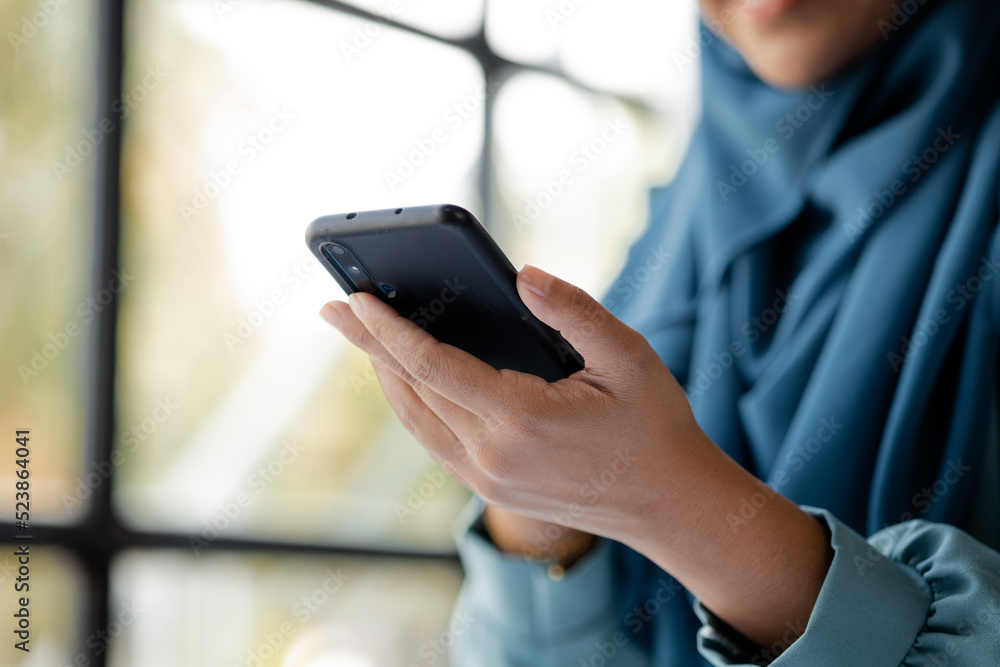 Asian women in hijab are using the mobile phone, administration and operations from the young, smart working women. The management concept drives the company of women leaders to grow. Asian women in hijab are using the mobile phone, administration and operations from the young, smart working women. The management concept drives the company of women leaders to grow.