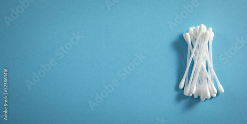 Cotton buds or swabs for ear cleaning on the blue background.