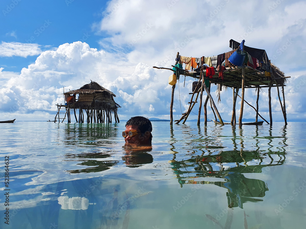Bajau laut or sea gypsy fishermen near stilt house in Maiga island